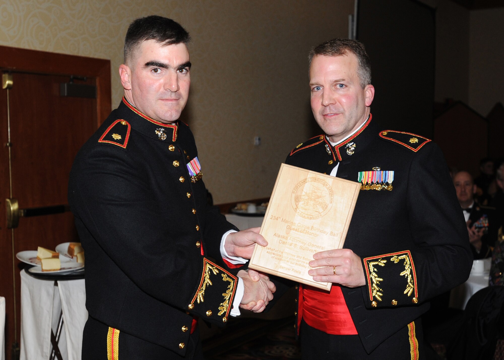 ANCHORAGE, Alaska -- Maj. William Allen, commander of D Company (-) Anti-Terrorism Battalion 4th Marine Divisio, presents Alaska Attorney General Daniel Sullivan with a plaque during the United States Marine Corps 234th Birthday Ball Nov. 21, 2009 at the downtown Anchorage Hilton. Sullivan, a prior Major in the Corps, was given the plaque in appreciation for being the guest speaker at the ball. (U.S. Air Force photo/Senior Airman Laura Turner)