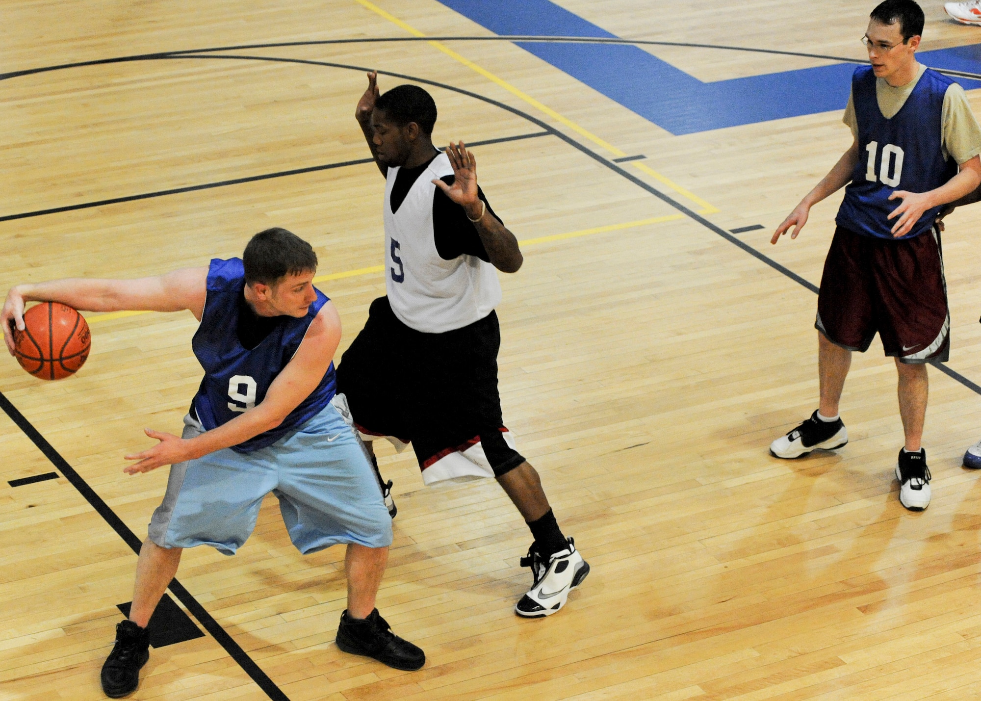 ELMENDORF AIR FORCE BASE, Alaska -- The 381st Intelligence Squadron's Dan Robinson protects the ball after rebounding a 3rd Communication Squadron missed shot. The 3rd CS came out on top with a final score 74-55. (U.S. Air Force photo/Airman 1st Class Christopher Gross)