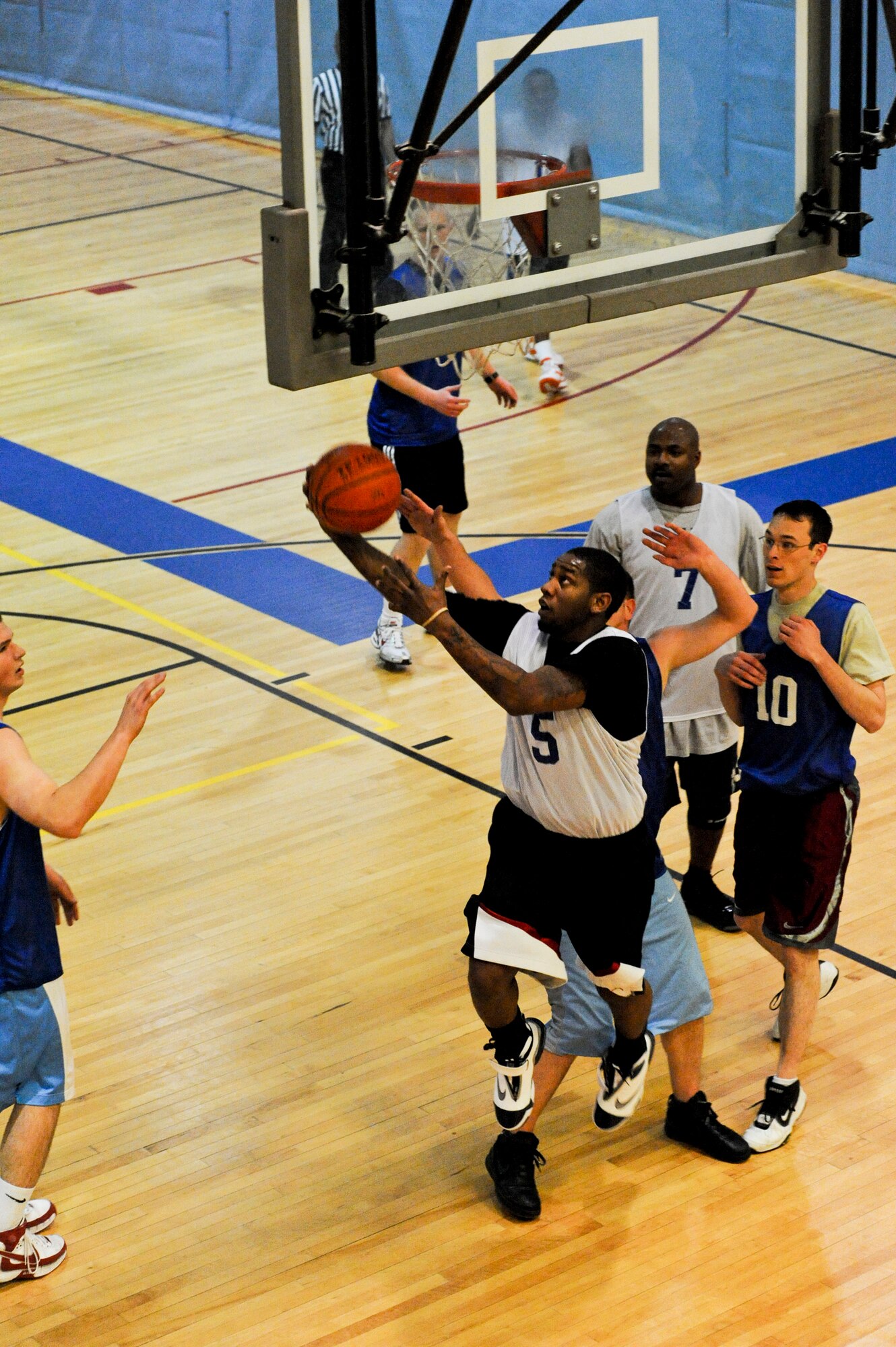 ELMENDORF AIR FORCE BASE, Alaska -- Paul Gilyard, playing for the 3rd Communication Squadron, goes for a layup underneath the basket Nov. 24 in a game against the 381st Intelligence Squadron.  The 3rd CS came out on top with a final score 74-55. (U.S. Air Force photo/Airman 1st Class Christopher Gross)