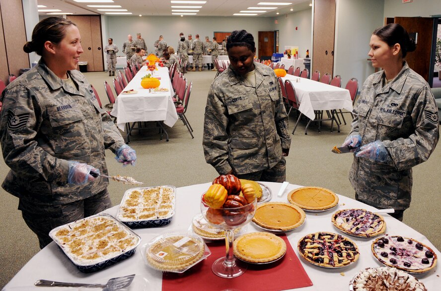 MOODY AIR FORCE BASE, Ga. -- Senior Airman Keturah Curtis, 23rd Logistics Readiness Squadron vehicle operations dispatcher, examines the desert table during the Airmen Thanksgiving Luncheon here Nov. 24. Tech. Sgt. Kristy Beaudoin, 23rd Equipment Maintenance Squadron aircraft structural maintenance craftsman, and Staff Sgt. Tasha Samudio, 23rd Equipment Maintenance Squadron aerospace ground equipment craftsman, came out to serve the dessert to Airmen who attended the event. (U.S. Air Force photo by Airman 1st Class Joshua Green)