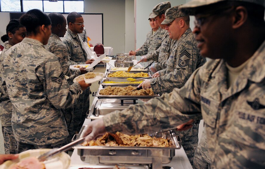 MOODY AIR FORCE BASE, Ga. -- Chief master sergeants at Moody serve Airmen a Thanksgiving meal during a luncheon held at the base chapel here Nov. 24. Chiefs and senior noncommissioned officers on base came out to show Airmen their appreciation while serving them a Thanksgiving lunch. (U.S. Air Force photo by Airman 1st Class Joshua Green)