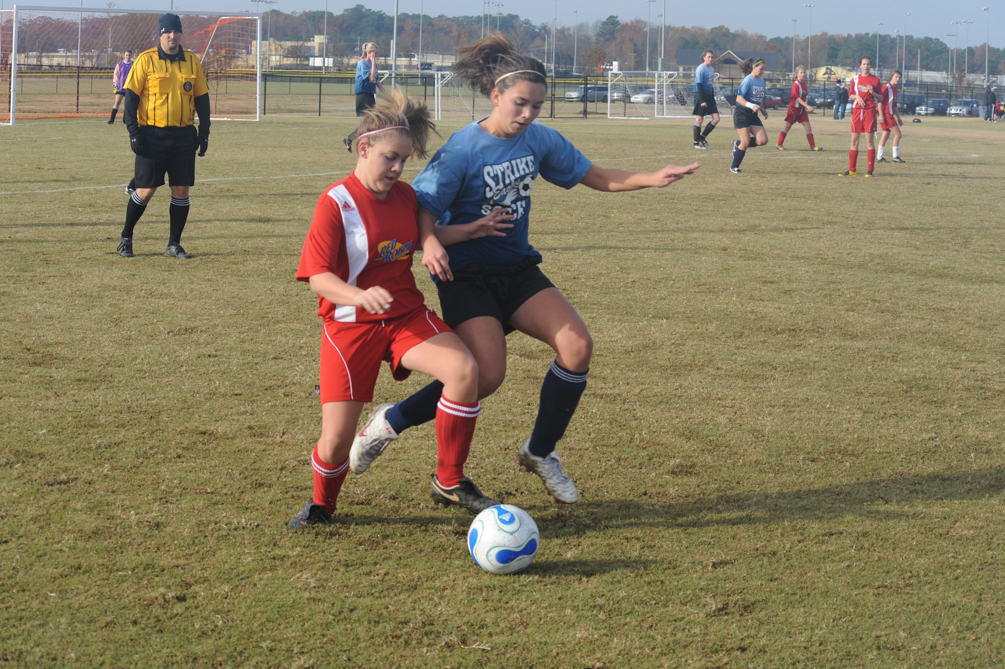 Breanna Donnelly, Strike Eagle FC midfielder, battles for the ball against a Burlington-Red Robin player during the teams’ first match of a two-day 2009 State Wide Athletic Counsel Tournament held at the Rocky Mount Sports Complex, in Rocky Mount, N.C., Nov. 21-22, 2009.  Burlington-Red Robin won the game, 4-1. (U.S. Air Force photo/Tech. Sgt. Lesley Waters)