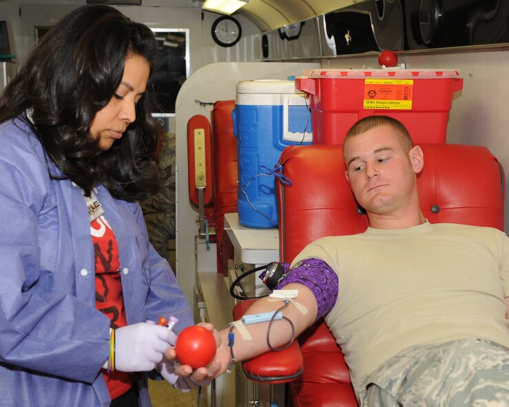 DYESS AIR FORCE BASE, Texas -- Nonmi Lucio, Meek Blood Center blood bank technician, takes vials of blood from Senior Airman Nicholas Meppid, 7th Logistics Readiness Squadron vehicle operator, during the blood drive at the Hangar Center here, Nov. 18.  Dyess members came together with Meeks Blood Center to donate blood that will benefit community members within the city of Abilene and the surrounding areas. (U.S. Ai r Force photo/Senior Airman Jenifer H. Calhoun)