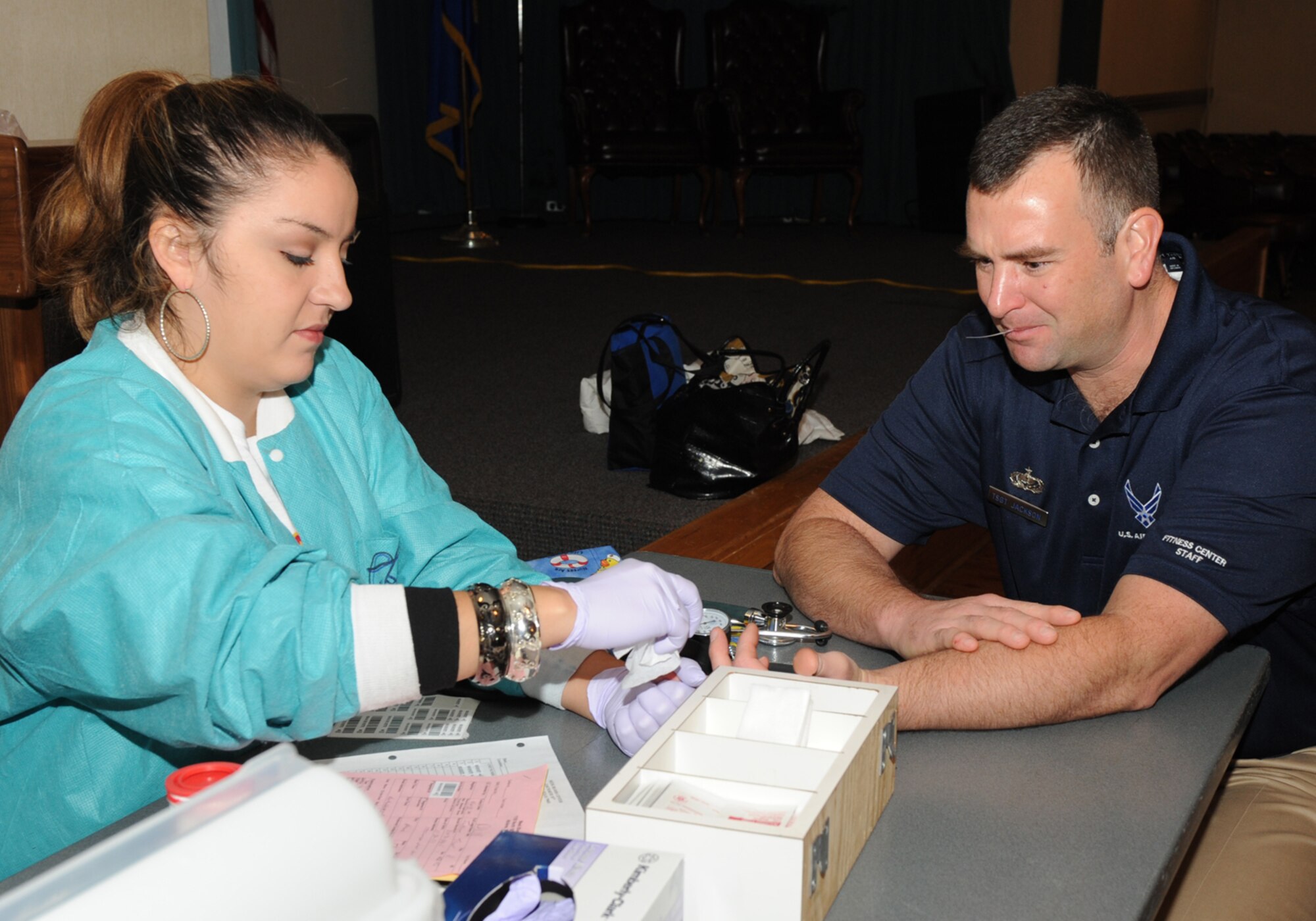 DYESS AIR FORCE BASE, Texas -- Tech. Sgt. Trevor Jackson, Dyess Fitness Center NCO in charge, has his vital sighns checked by Stephanie Perez, to verify that he qualifies to donate blood at the Hangar Center here, Nov. 18.  Dyess members came together with Meeks Blood Center to donate blood that will benefit community members within the city of Abilene and the surrounding areas. (U.S. Ai r Force photo/Senior Airman Jenifer H. Calhoun)