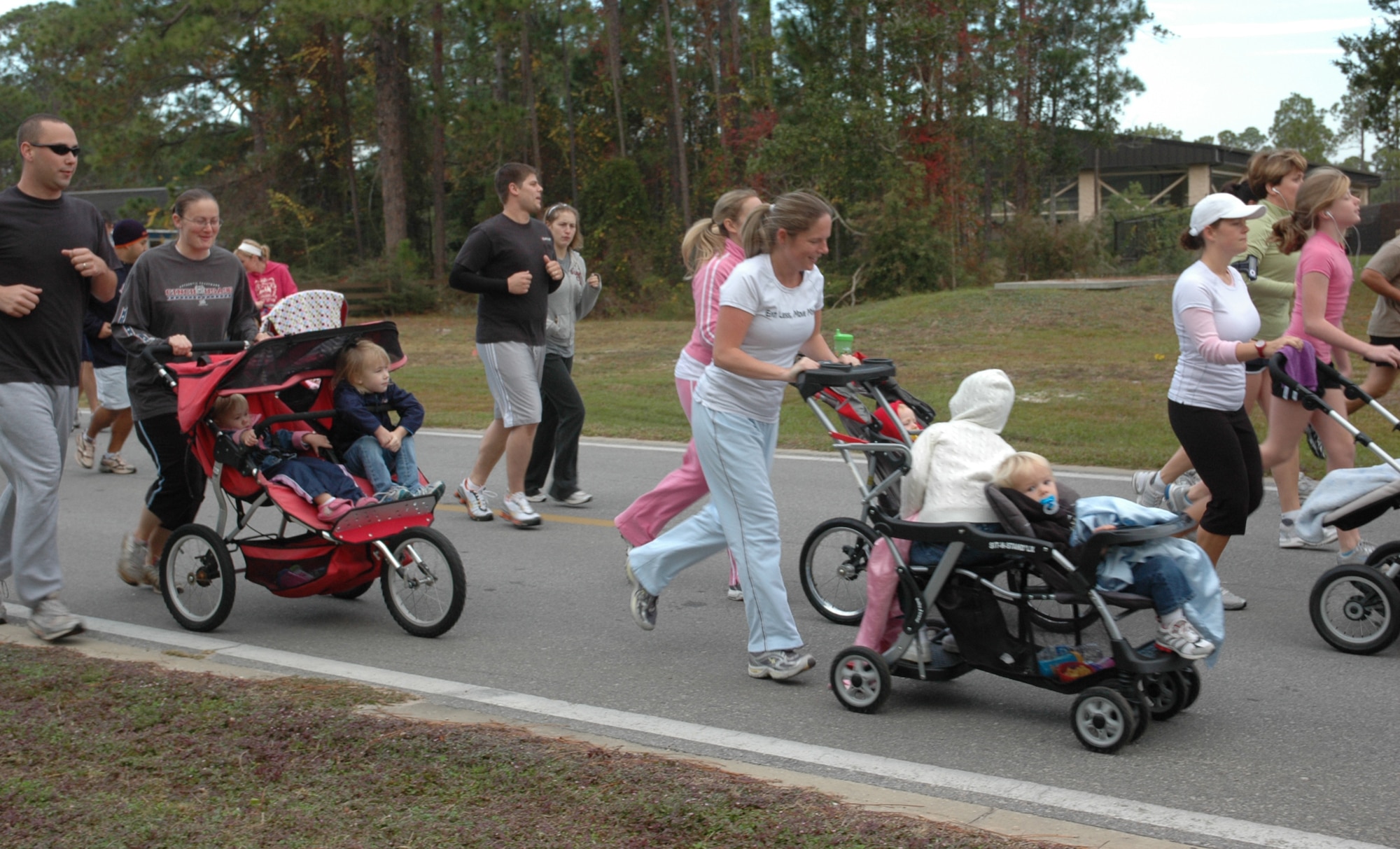 Participants run with their children in strollers during the 5k Turkey Trot at the Aderholt Fitness Center at Hurlburt Field Nov. 25. Event organizers said that attendance at this year’s run was the most of any previous Turkey Trot.  (Air Force photo by Airman 1st Class Joe McFadden)