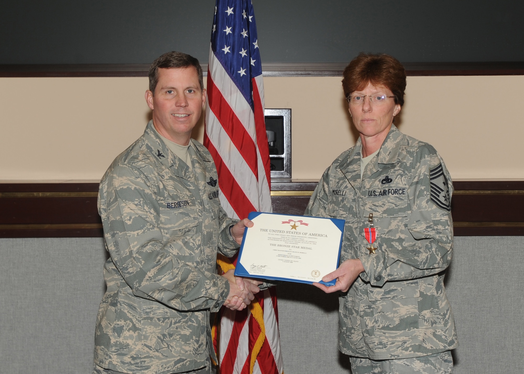 ELMENDORF AIR FORCE BASE, Alaska-- Chief Master Sgt. Diane Morelli, 3rd Equipment Maintenance Squadron, receives a Bronze Star certificate from Col. Thomas Bergeson, 3rd Wing commander, Nov. 24, 2009. (U.S. Air Force photo/ Airman 1st Class Kristin High)