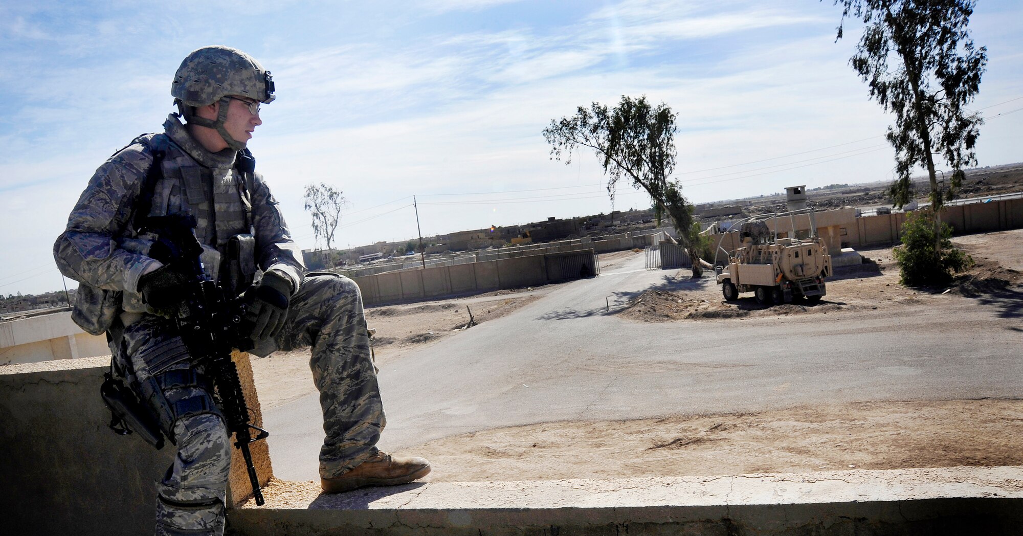 Senior Airman Christopher Cable provides security at a local police station during a meeting, Nov. 15, 2009, at Baghdad, Iraq. The meeting was held as part of a mentorship effort that aims to ensure the Iraqi police are trained in how to collect data and serve warrants in their city. Airman Cable is a 732nd Expeditionary Security Forces Squadron Det 2 fire team member deployed to Baghdad, Iraq. (U.S. Air Force photo/Staff Sgt. Angelita Lawrence)