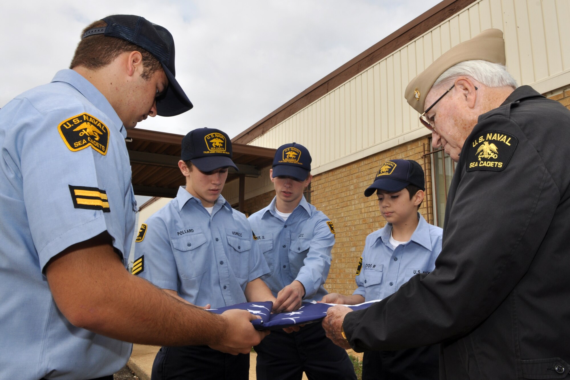 Warrant Officer 3 Randy Vanderstay, U.S. Navy League Cadets training officer, Tyler Joint Force Battalion, assists in the training U.S. Naval Sea Cadet Corp cadets Clayton Sims, Harrison Pollard, Sam Fiser and Robert Cloos for a U.S. Flag Retirement Ceremony at the American Legion Post 12 in Tyler, Texas, November 21, 2009. Early next year, the TJFB cadets plan to retire more than 100 flags that have been collected by various organizations and individuals. The ceremony is used to promote American Heritage and provide a Community service by honorably disposing of worn United States Flags. (Courtesy photo)