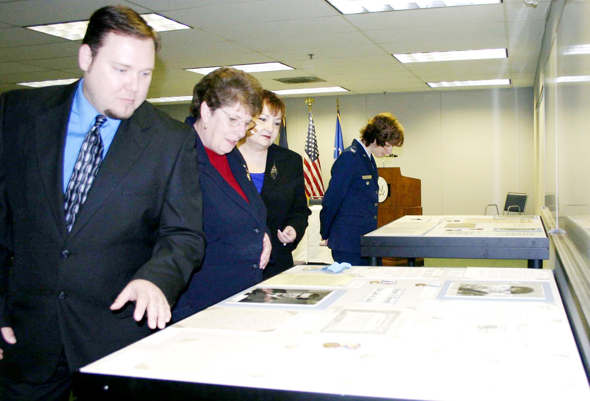 Mike Green (left to right), Jo Hogue, Barbara Duggan and Col. Julie Robel review some of the original military personnel files of Air Force pioneers on display at the National Personnel Records Center during a ceremony Nov. 18, 2009 in St. Louis. The ceremony marked the historic transfer of ownership of approximately 177,000 official military personnel files from the Air Force to the National Archives and Records Administration. (U.S. Air Force photo/Daniel P. Elkins)