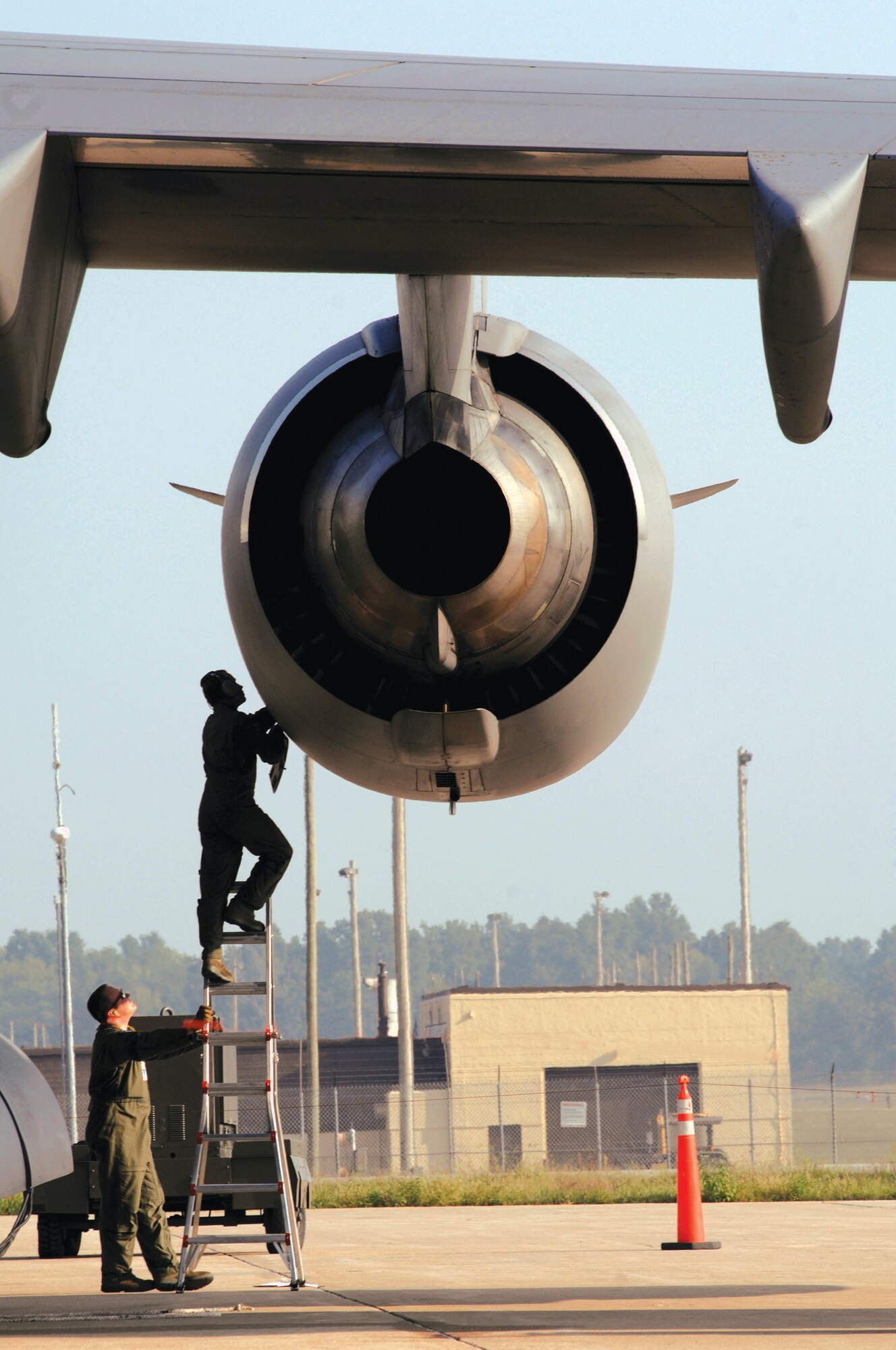 Airman perform checks on an F117 engine powering a C-17 cargo aircraft. The engines will soon be maintained at Tinker's Oklahoma City Air Logistics Center. It is the largest engine yet to be maintained here. 