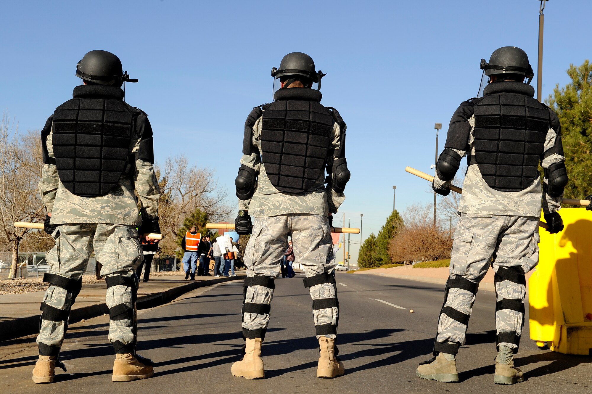BUCKLEY AIR FORCE BASE, Colo. -- The Buckley Air Force Base Confrontation Management Team makes a barrier at the main gate during an exercise Nov. 24. (U.S. Air Force photo by Staff Sergeant Steve Czyz)