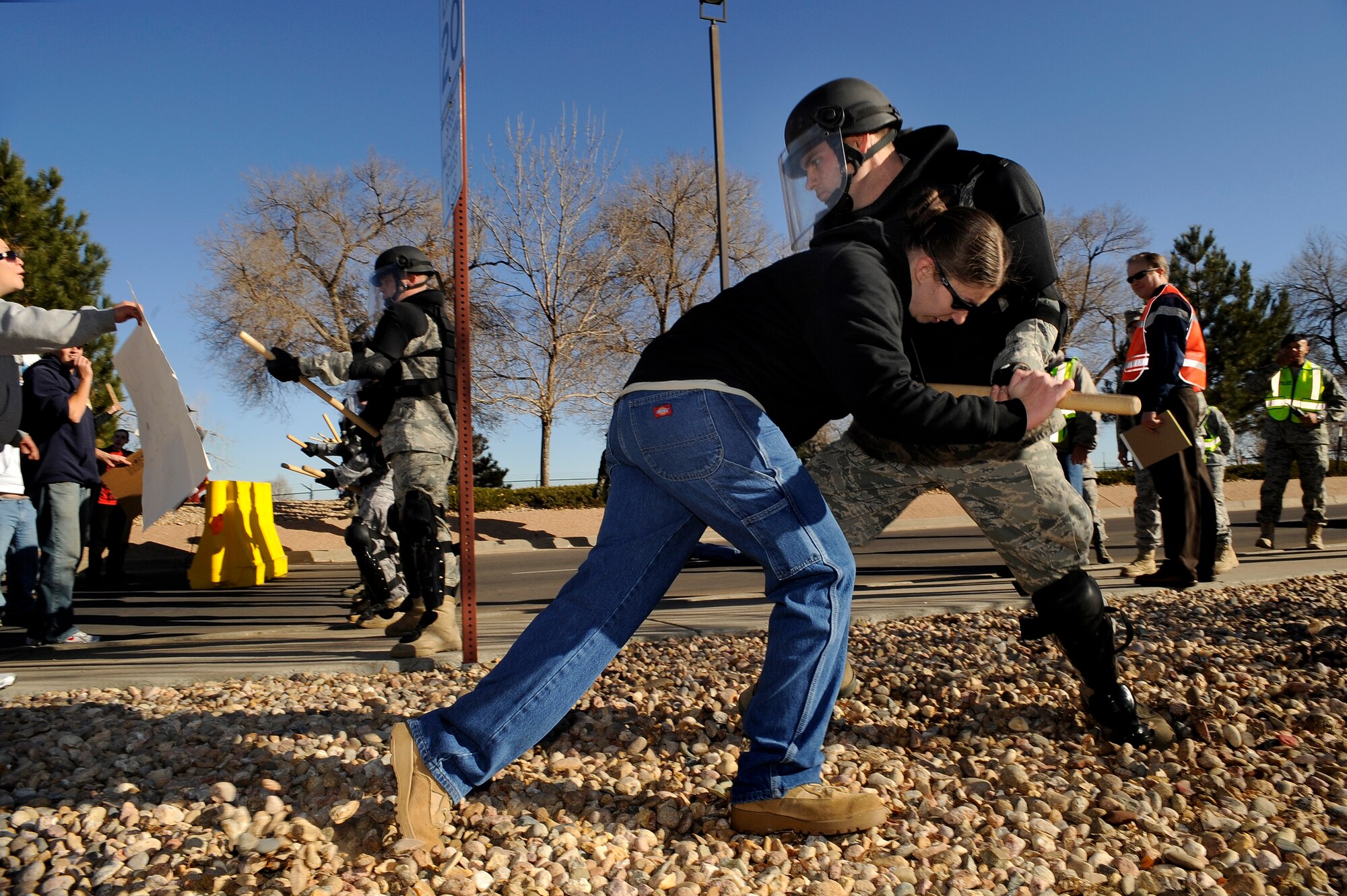 BUCKLEY AIR FORCE BASE, Colo. -- Staff Sgt. Kaitlan Manning, 566th Intelegence Squadron, tries to break through the Confrontation Management Team's barrier during an exercise Nov. 24. (U.S. Air Force photo by Staff Sergeant Steve Czyz)