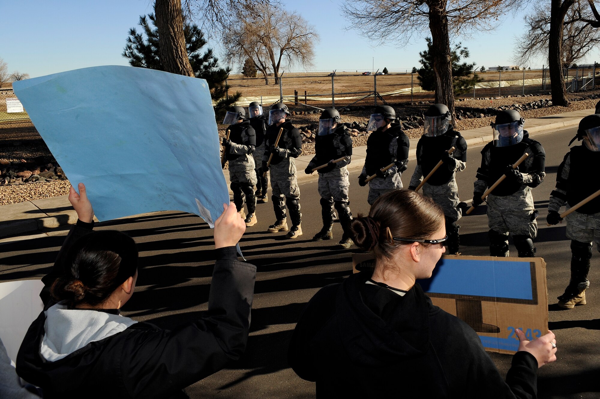 BUCKLEY AIR FORCE BASE, Colo. -- The Buckley Air Force Base Confrontation Management Team makes a barrier at the main gate of the base during an exercises Nov. 24. (U.S. Air Force photo by Staff Sergeant Steve Czyz)