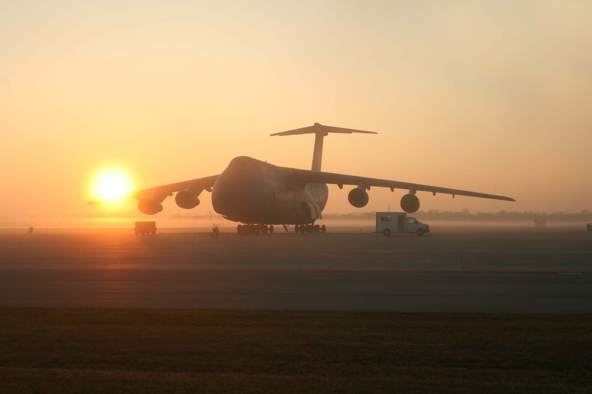 A C-5 Galaxy from the 445th Airlift Wing waits for the next mission as the sun rises Nov. 21, 2009, at Wright-Patterson Air Force Base, Ohio. (U. S. Air Force photo/Senior Airman Robert Nelson)