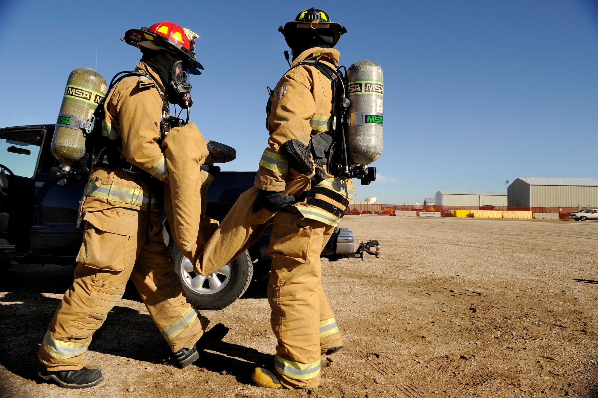 BUCKLEY AIR FORCE BASE, Colo. -- Buckley firefighters carry a simulated victim from a truck during an exercise Nov. 24. (U.S. Air Force photo by Staff Sergeant Steve Czyz)