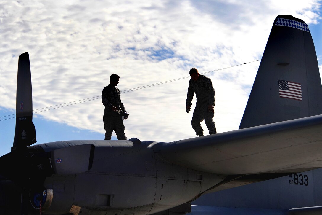 Two C-130 Hercules crew chiefs conduct a post-flight inspection of their aircraft during a Mobility Air Forces Exercise Nov. 18, 2009, at Nellis Air Force Base, Nev. About 40 C-17 Globemaster IIIs and C-130 aircraft from Air Force bases around the world flew approximately 400 Soldiers from Fort Bragg, N.C., during the airdrop portion of the exercise. (U.S. Air Force photo/Lawrence Crespo) 