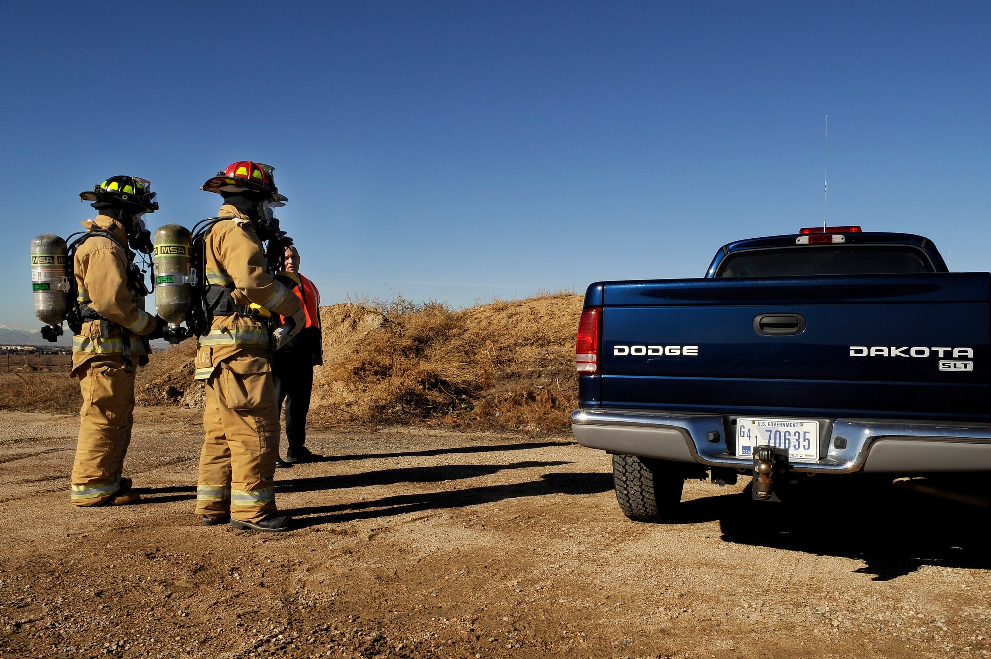 BUCKLEY AIR FORCE BASE, Colo. -- Buckley Firefighters plan their approach to enter a dangerous vehicle during an exercise Nov. 24. (U.S. Air Force photo by Staff Sergeant Steve Czyz)