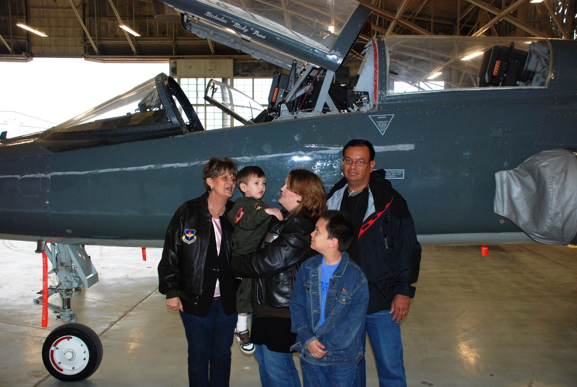 LAUGHLIN AIR FORCE BASE, Texas – Nicholas “Nicky” Pena and his family pose in front of a T-38 aircraft that bears Pena’s name during his Pilot for a Day activities here Nov. 20. Pena was able to participate in numerous activities during his big day including tours of the 87th Flying Training Squadron and Laughlin’s fire station. (U.S. Air Force photo by Airman 1st Class Blake Mize)