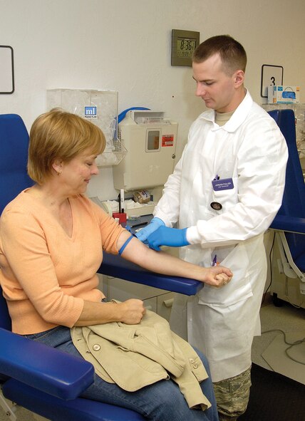 Airman 1st Class Jordan Fuller prepares to draw blood from retiree spouse, Kathi Gold of Bethany.  An average of 100 patients a day will have their blood drawn in the lab. (Air Force photo by Margo Wright)