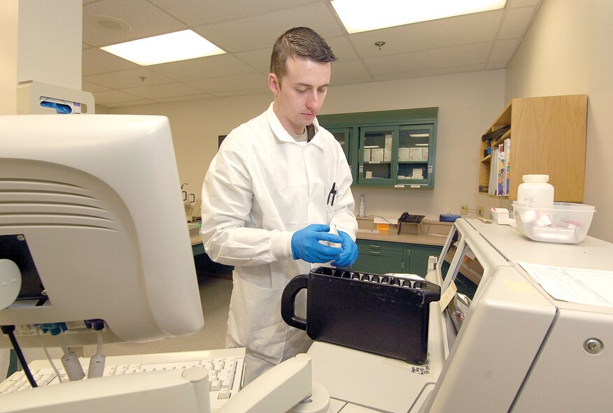 Senior Airman Jeremy Stover, performs a bi-weekly humidity pack change in a medical laboratory chemical testing machine.  Tests require varying and precise humidity and temperature levels according to the chemistry being tested. (Air Force photo by Margo Wright)