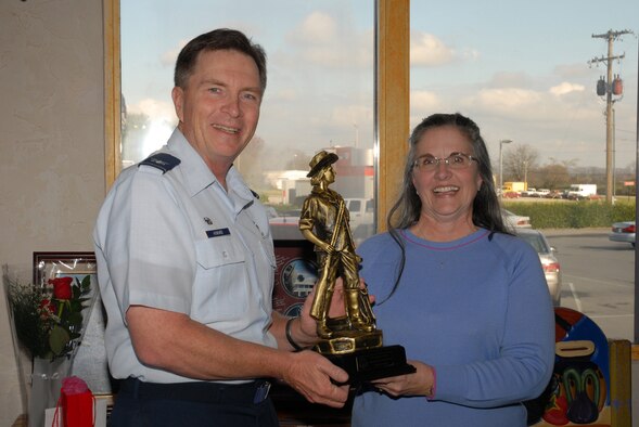 McGHEE TYSON AIR NATIONAL GUARD BASE, Tenn. -- Col. Richard B. Howard, commander of The I.G. Brown Air National Guard Training and Education Center, here, presents the honorary faculty award to Edna C. Davis, secretary, upon her retirement from civil service at a local restaurant, Nov. 23, 2009.  Davis worked for 17 years as the secretary for the Academy of Military Science, the Air National Guard's officer commissioning program.  (U.S. Air Force photo by Master Sgt. Mavi Smith/Released) 