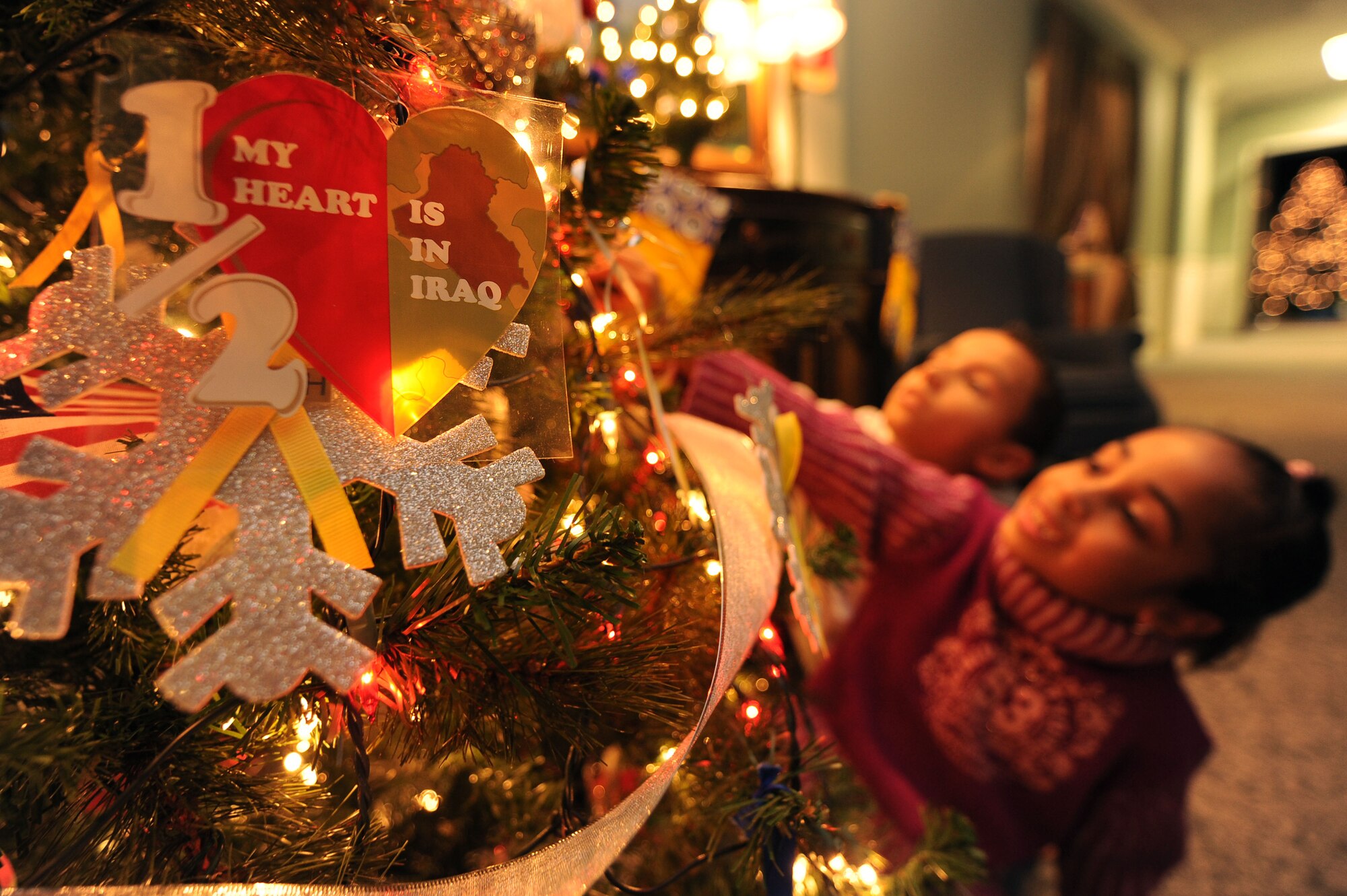 SHAW AIR FORCE BASE, S.C. -- Danell and Nyanna Scott, children of Staff Sgt. Dennis Scott, 79th Aircraft Maintenance Unit, hang ornaments on the deployed christmas tree Nov. 23. (U.S. Air Force Photo/Senior Airman David Minor)