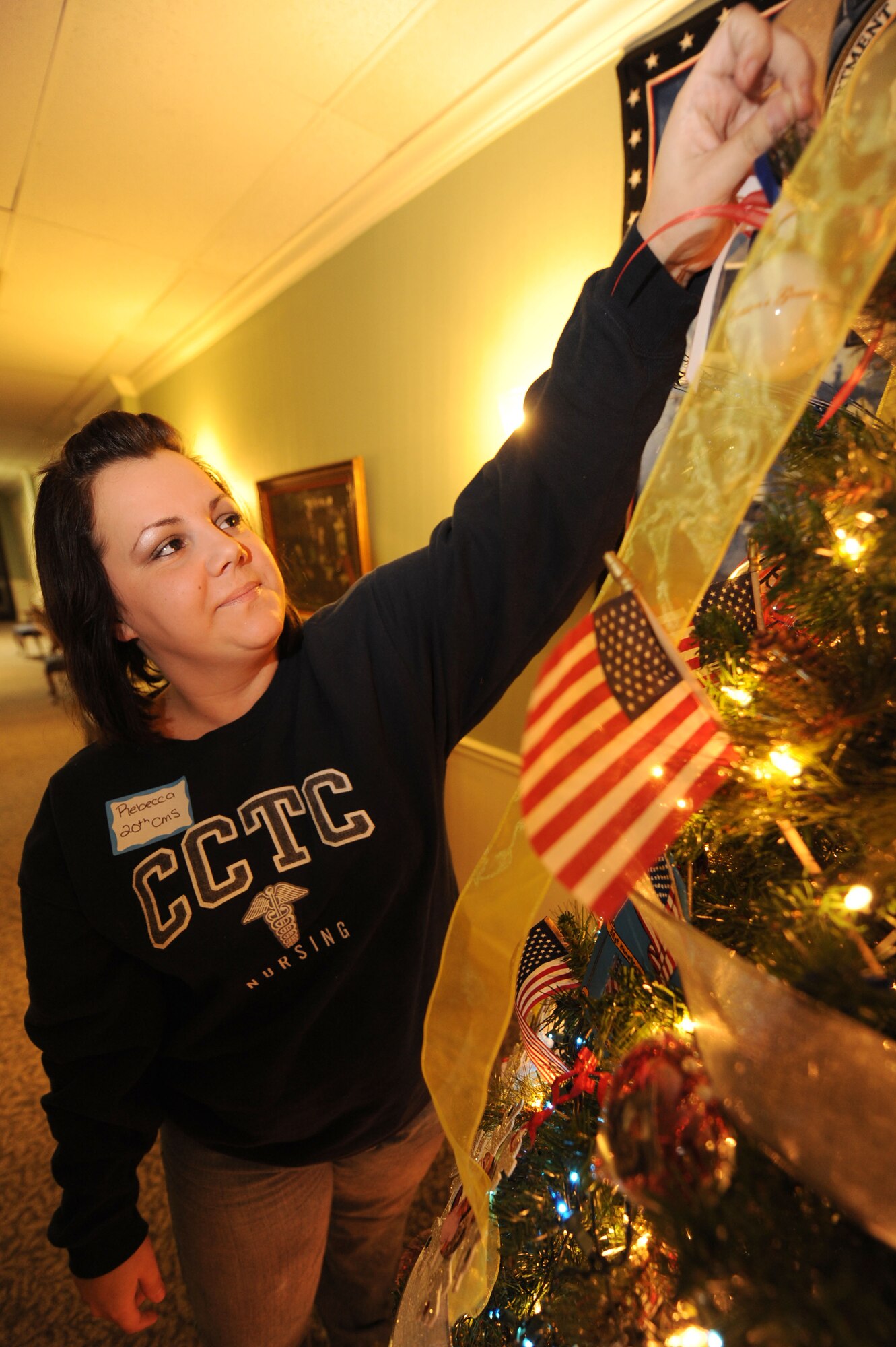 SHAW AIR FORCE BASE, S.C -- Rebecca Blanton, wife of Senior Airman Micah Blanton, 20th Component Maintenace Squadron, hangs an ornament on the deployment tree Nov. 23. (U.S. Air Force photo/Senior Airman David Minor)