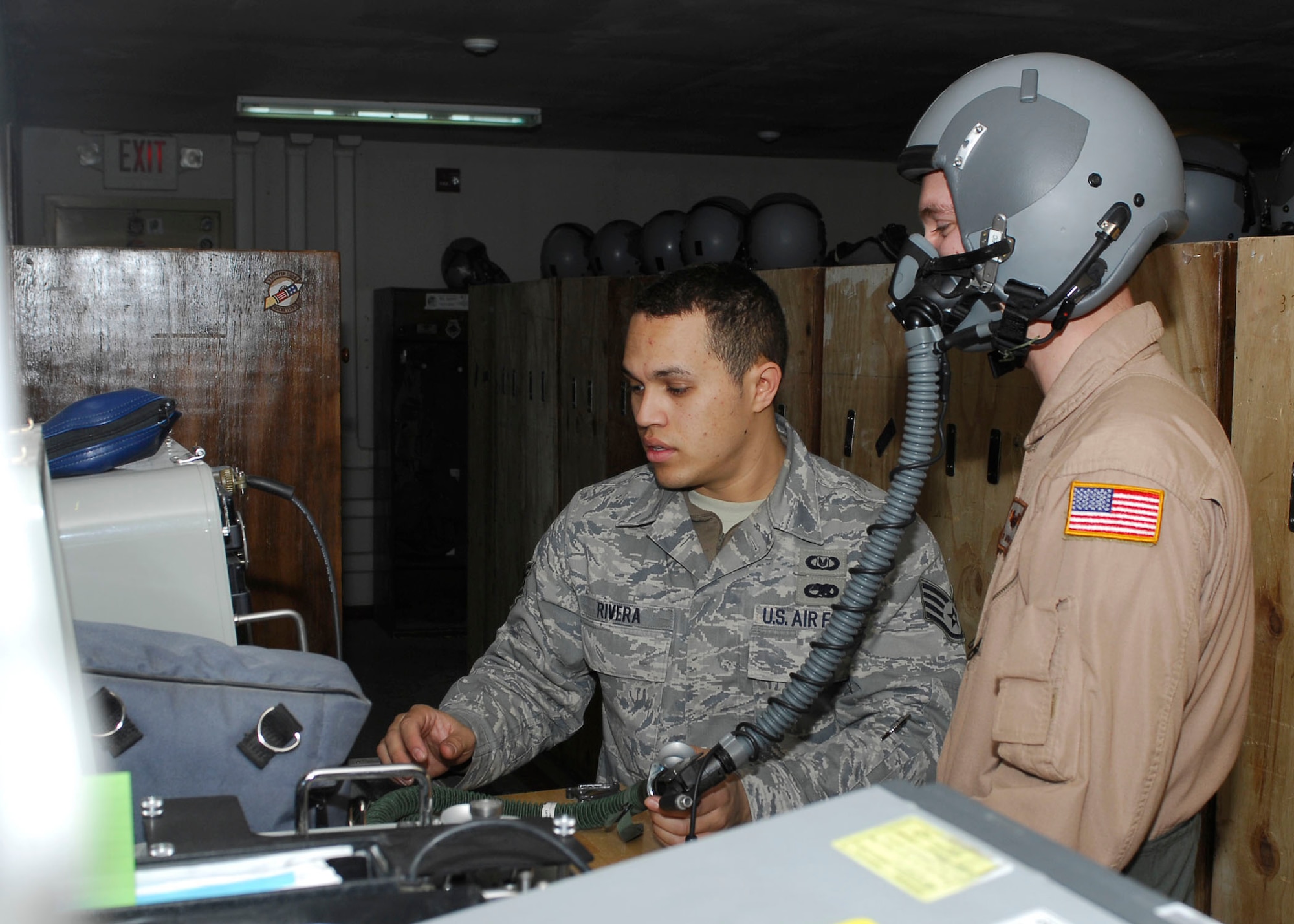 BAGRAM AIRFIELD, Afghanistan -- Staff Sgt. Michael Keller (right), a combat camera Airman, gets his oxygen mask checked by  Staff Sgt. Jonathan Rivera (left), an aircrew flight equipment journeyman, Nov. 25, 2009.  A combat camera Airman is flying with the Fighters to visually tell their story.  The mask has to be checked for cracks and holes to ensure that Sergeant Keller receives the proper amount of oxygen.  Sergeant Keller is deployed from Charleston Air Force Base, S.C., and hails from Clarkrange, Tenn.  Sergeant Rivera, a Puerto Rico native, is deployed from Seymour Johnson, N.C.  (U.S. Air Force photo/Senior Airman Felicia Juenke)