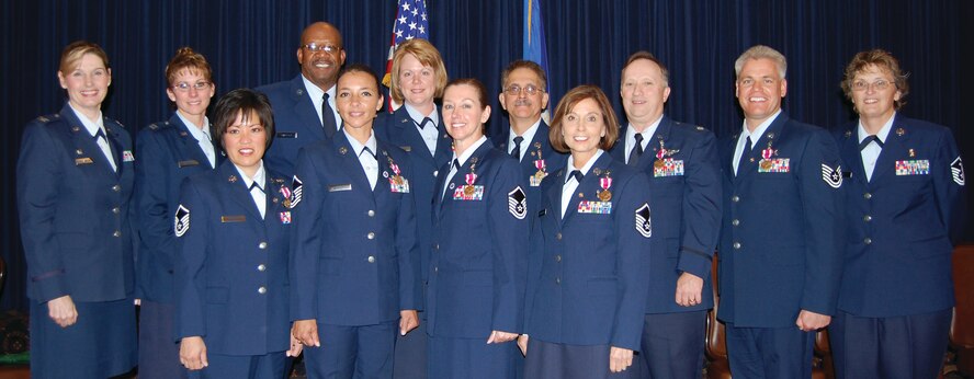 Ten 710th Medical Squadron retirees participate in a mass retirement ceremony Oct. 3 at the Patriot Club prior to the squadron's deactivation. Back from left: 710th MDS Commander Col. Joan Gonzalez, Capt. Kami L. Willett, Master Sgt. Jeffrey J. Sparrock, Lt. Col. Shelly R. Kinney, Chief Master Sgt. Steven J. Gambaiana, Lt. Col. Howard E. Phillippi, Tech. Sgt. John A. Yonkers , 710th MDS First Sergeant Kelly Kay. Front from left: Master Sgt. Audrey L. Bennett, Master Sgt. Anna L. Sewell, Master Sgt. Jean F. Tait and Master Sgt. Debra A. Bernhardt pose for a group photo. Between them, the retirees served more than 250 years in the U.S. Air Force. The 710th MDS is a geographically separated unit of the 442nd Fighter Wing, Whiteman Air Force Base, Mo. (U.S. Air Force photo by Debbie Aragon) 