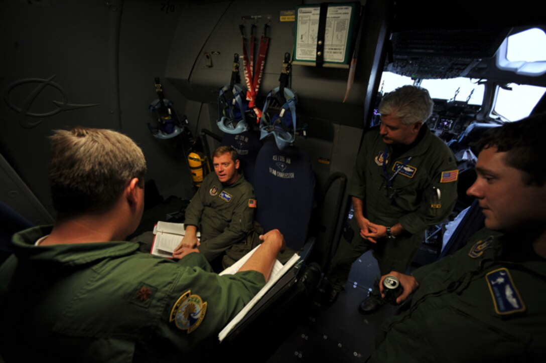 Pilots assigned to the 300th Airlift Squadron go over multiple publications as they wait to take off from Charleston AFB, S.C. on November 23, 2009. (U.S. Air Force photo/Staff Sgt. Quinton Russ)