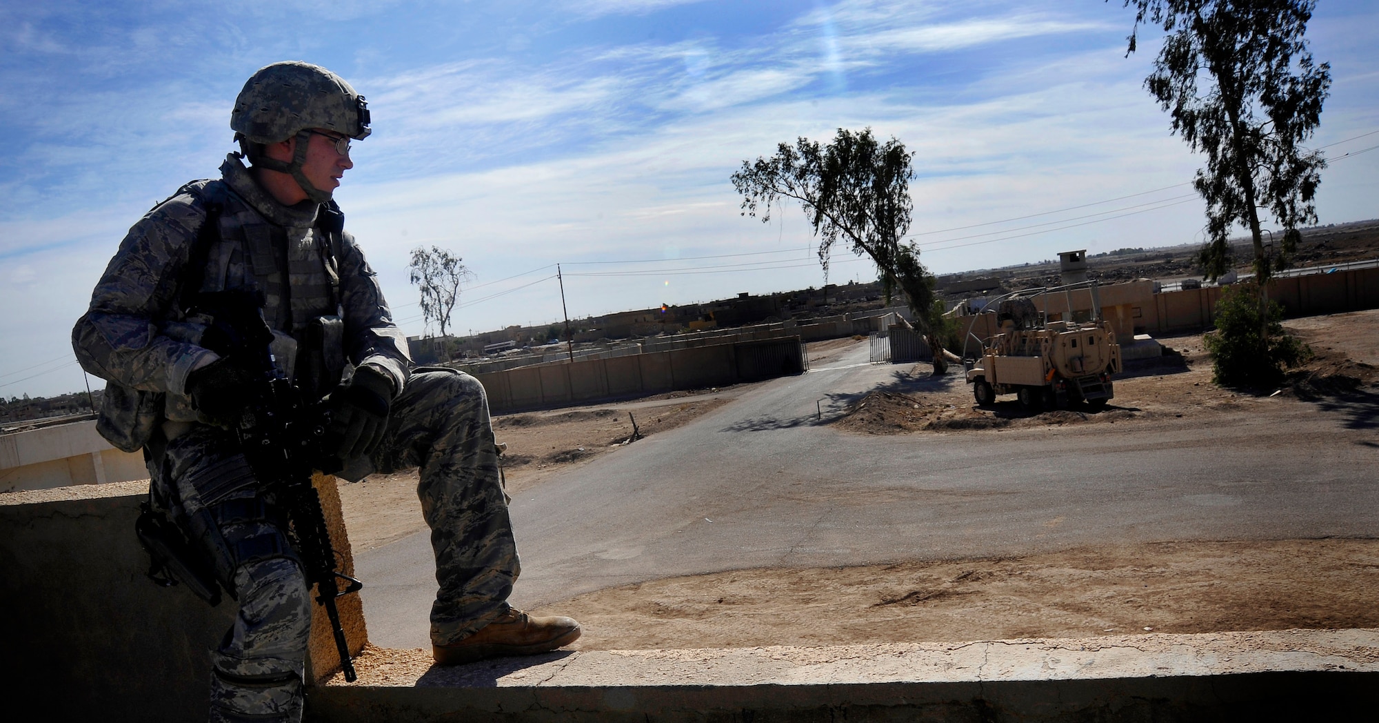 U.S. Air Force Senior Airman Christopher Cable, 732nd Expeditionary Security Forces Squadron Det 2 fire team member, deployed to Baghdad, Iraq, provides security at a local police station during a meeting, Nov. 15, 2009. The meeting was held as part of a mentorship effort that aims to ensure the Iraqi police are trained in how to collect data and serve warrants in their city. (U.S. Air Force photo/Staff Sgt. Angelita Lawrence)