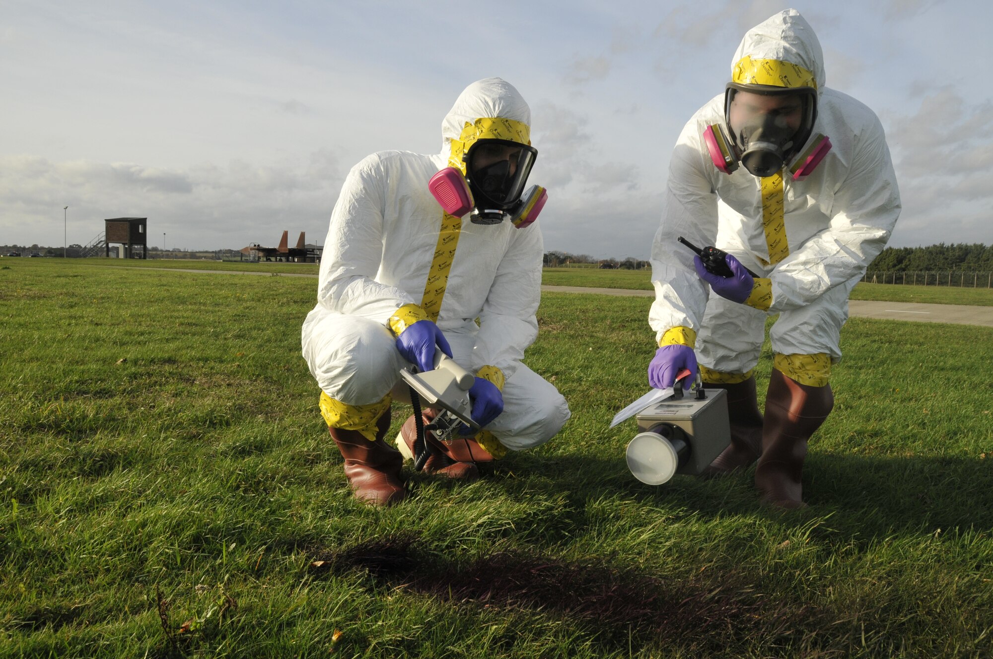 Airmen Matthew Kindoll and Kris Coccioco, 48th Medical Group Bioenvironmental technicians, check the surrounding area for radiological chemicals or fire hazards during the emergency management exercise on RAF Lakenheath, England, Nov.19.  Bioenvironmental was assessed on their response efficiency in conjunction with the other base response teams during an emergency by the 48th Fighter Wing Vvice Commander Inspection team. (U.S. Air Force photo by Airman 1st Class Eboni Knox)