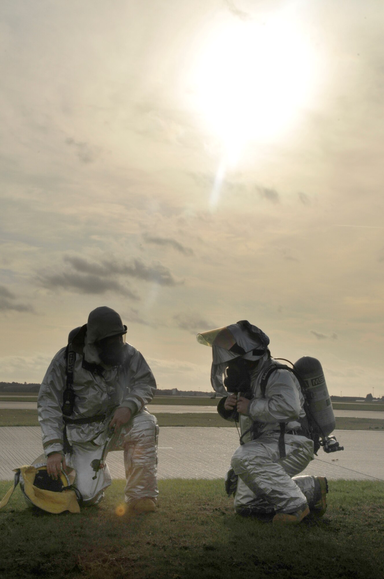 Staff Sgt. Henry Stratton and Tech. Sgt. Chad Malley, 48th Civil Engineer Squadron Fire Protection crew chiefs, take off their protective gear and catch a breath after transporting victims from a simulated building on fire during an emergency management exercise on RAF Lakenheath, England, Nov. 19. The 48th Fighter Wing Vice Commander Inspection team uses the exercises to evaluate how the base response teams work together during emergencies in a controlled environment. (U.S. Air Force photo by Airman 1st Class Eboni Knox)