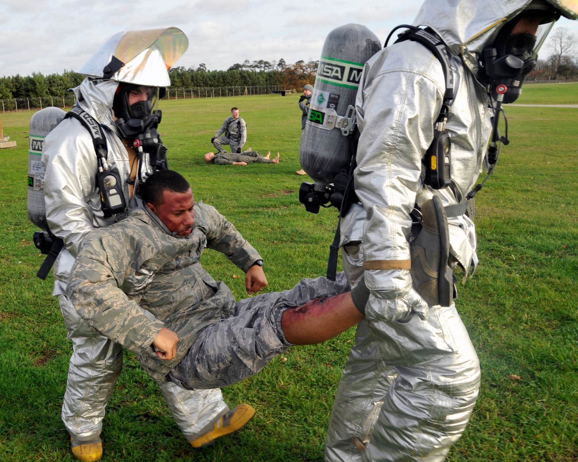 Staff Sgt. Henry Stratton and Tech. Sgt. Chad Malley, 48th Civil Engineer Squadron Fire Protection crew chiefs,  transport simulated accident victim, Staff Sgt. Larnell Mobley, to a safe area to be treated for injuries. They conducted intial aid until medical help could respond during a 48th Fighter Wing Vice Commander Inspection emergency management exercise on RAF Lakenheath, England, Nov. 19.  CVI  is responsible for assessing how effectively different response teams work together in an emergency environment. (U.S. Air Force photo by Airman 1st Class Eboni Knox)