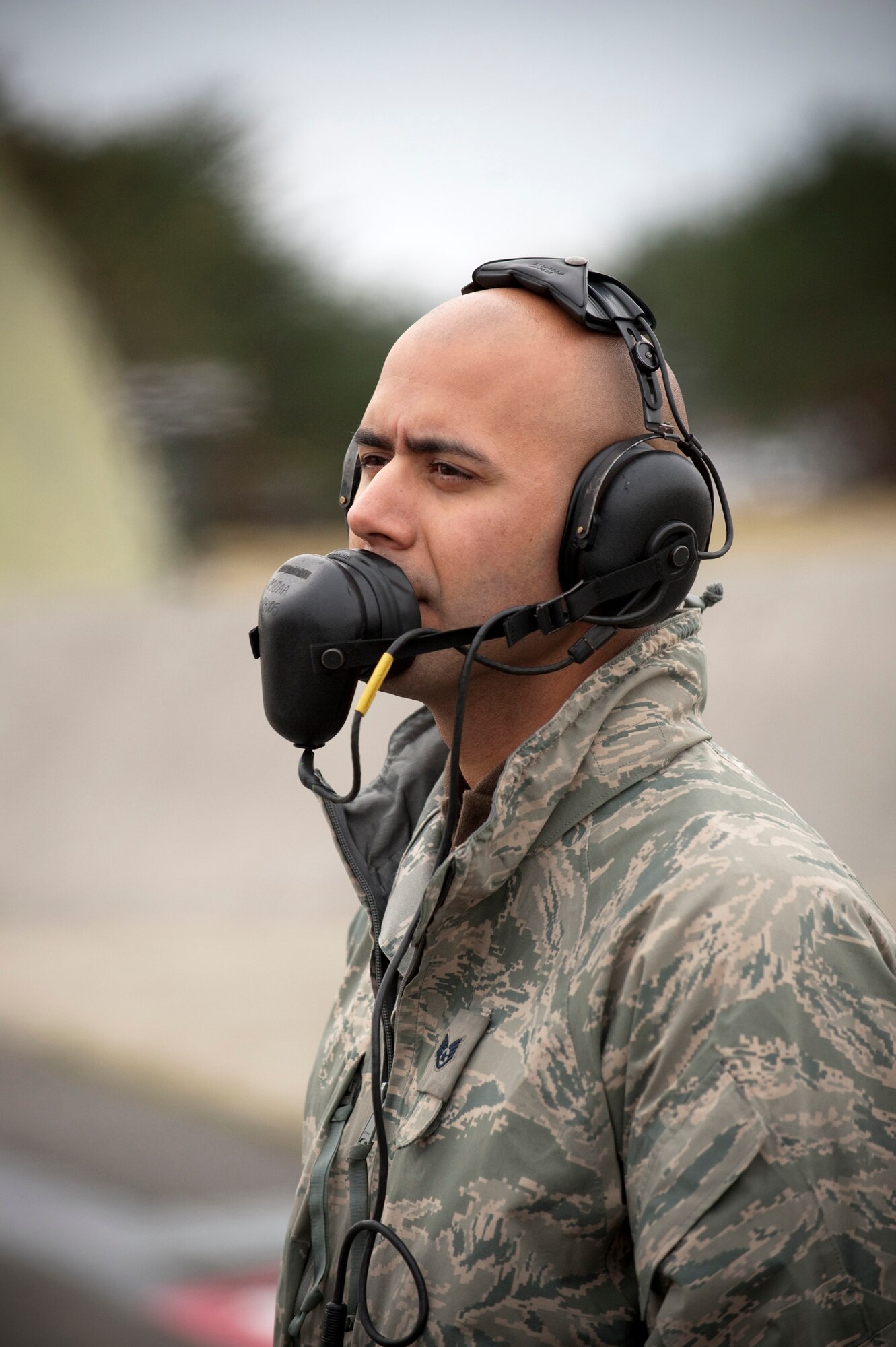 MISAWA AIR BASE, Japan -- Staff Sgt. Pablo Jimenez, 13th Aircraft Maintenance Unit crewchief, talks with the pilot during engine startup on the flightline Nov. 17. Headsets allow crewchiefs to stay in contact with their pilots despite the noise level associated with engine startup.  (U.S. Air Force photo/Staff Sgt. Samuel Morse)