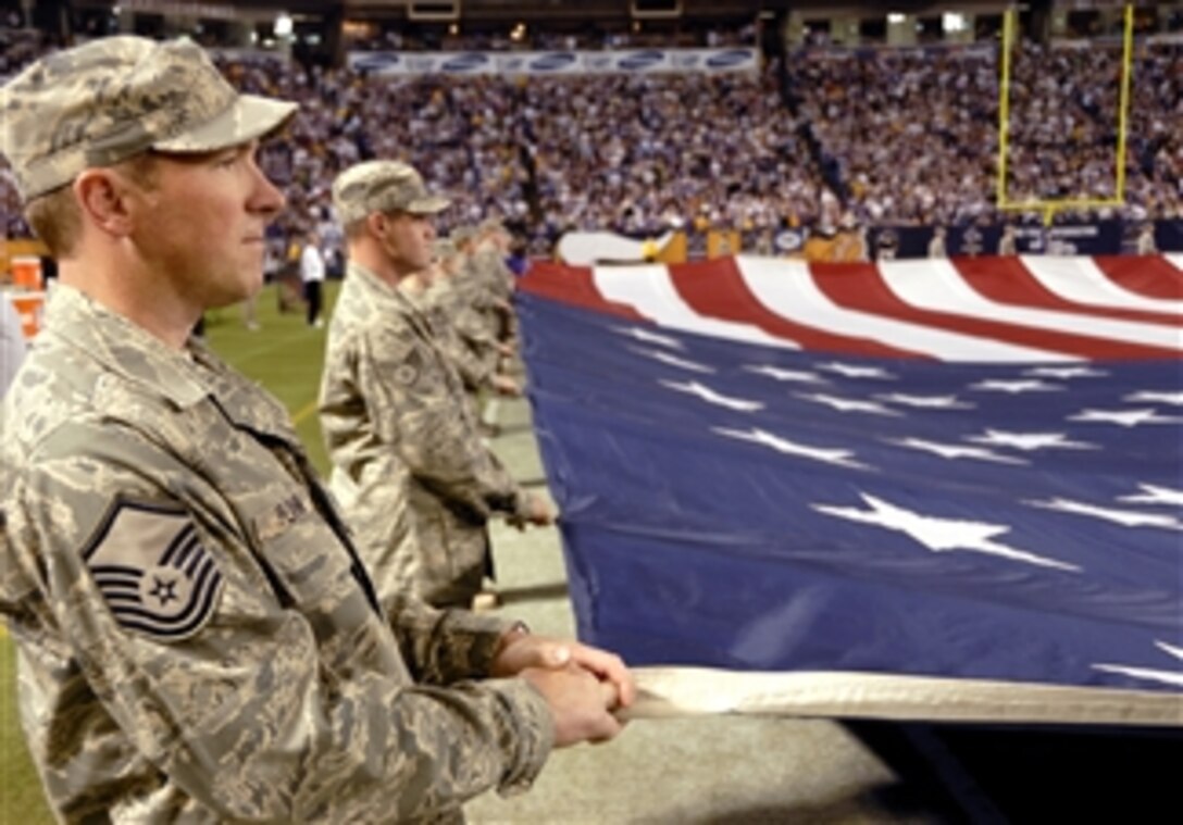 U.S. Air Force airmen hold a large U.S. flag during a Military Appreciation Game at the Metrodome in Minneapolis, Minn., on Nov. 15, 2009.  The 133rd Airlift Wing and 148th Fighter Wing provided airmen for on the field events during half time and pregame ceremonies.  
