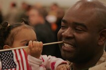 NEW YORK -- Sgt. Jeff Gerbier, motor transportation operator, 6th Communications Battalion, 4th Marine Logistics Group, Marine Forces Reserve, and Brooklyn native, holds his daughter after returning Marines to their Brooklyn headquarters. The Marines returned from their Iraq deployment, Nov. 25 just before the Thanksgiving Day holiday. (Official Marine Corps photo by Sgt. Randall A. Clinton)