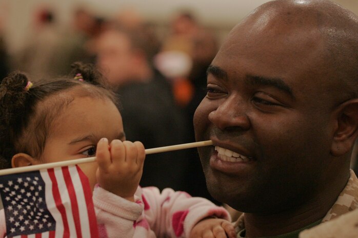 NEW YORK -- Sgt. Jeff Gerbier, motor transportation operator, 6th Communications Battalion, 4th Marine Logistics Group, Marine Forces Reserve, and Brooklyn native, holds his daughter after returning Marines to their Brooklyn headquarters. The Marines returned from their Iraq deployment, Nov. 25 just before the Thanksgiving Day holiday. (Official Marine Corps photo by Sgt. Randall A. Clinton)
