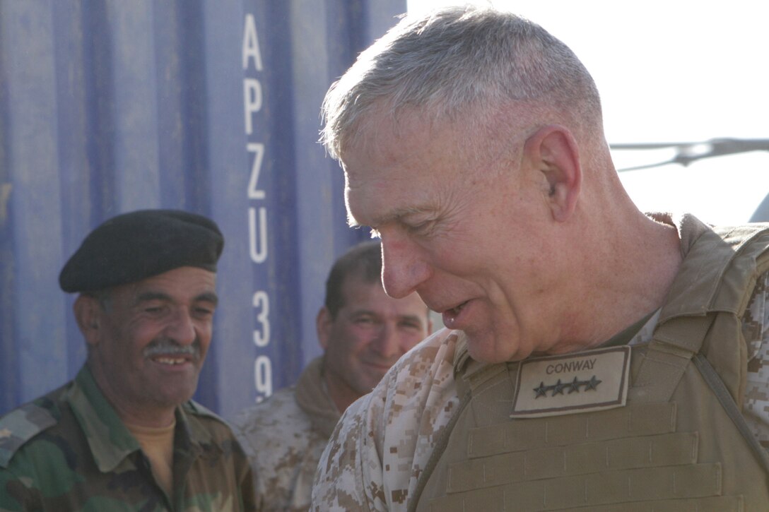 Gen. James T. Conway, the commandant of the Marine Corps, greets the Marines of 2nd Battalion, 2nd Marine Regiment, during his visit to Forward Observation Base Delhi, in Garmsir, Afghanistan, Nov. 26, 2009. The commandant and Sgt. Maj. Carlton W. Kent, the sergeant major of the Marine Corps visited the Marines of 2/2 to talk about current changes and issues throughout the Marine Corps.
