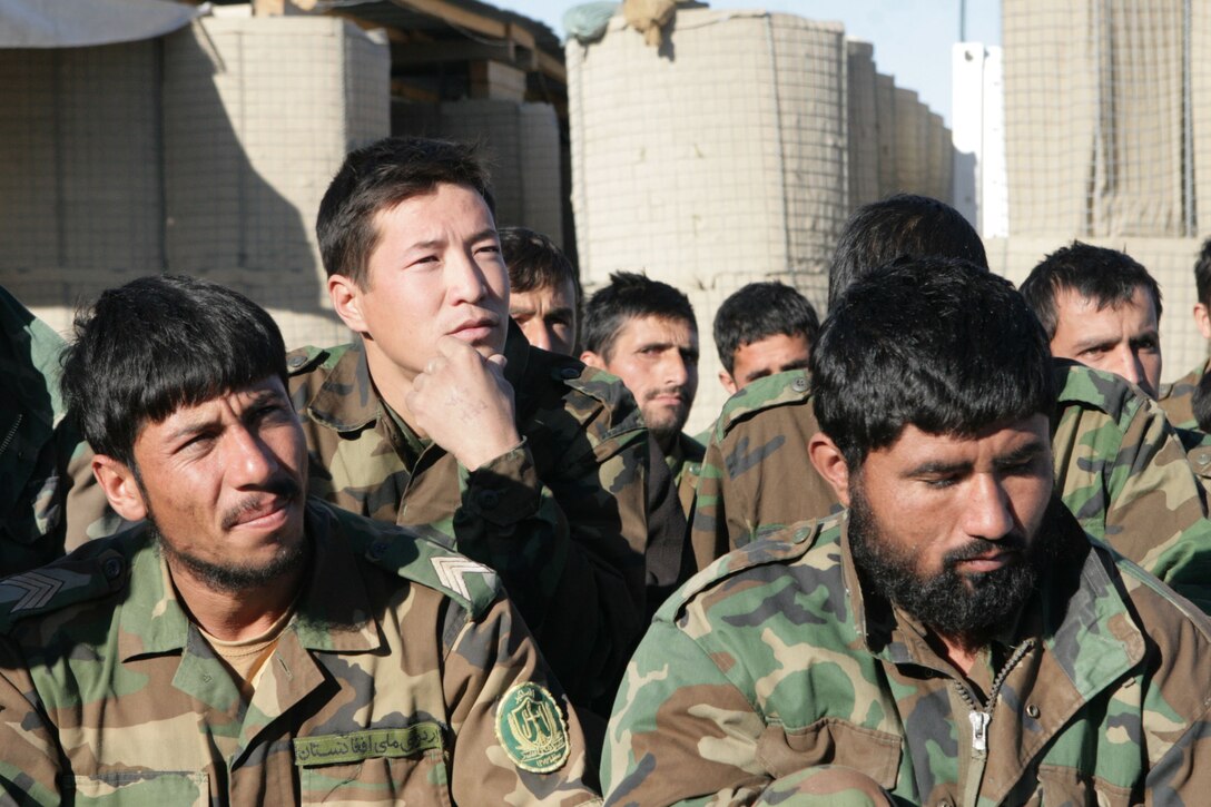 Members of the 6th Battalion, 3rd Brigade, 205th Corps, Afghan National Army, listen to a speech by Lt. Col. John E. McDonough, the commanding officer of 2nd Battalion, 2nd Marine Regiment, after their graduation ceremony at Patrol Base Shamshad, Nov. 26, 2009. Twenty-eight members of 6th Battalion graduated after two weeks of training headed by soldiers from 2nd Battalion, 508th Parachute Infantry Regiment, 4th Brigade Combat Team, 82nd Airborne Division.