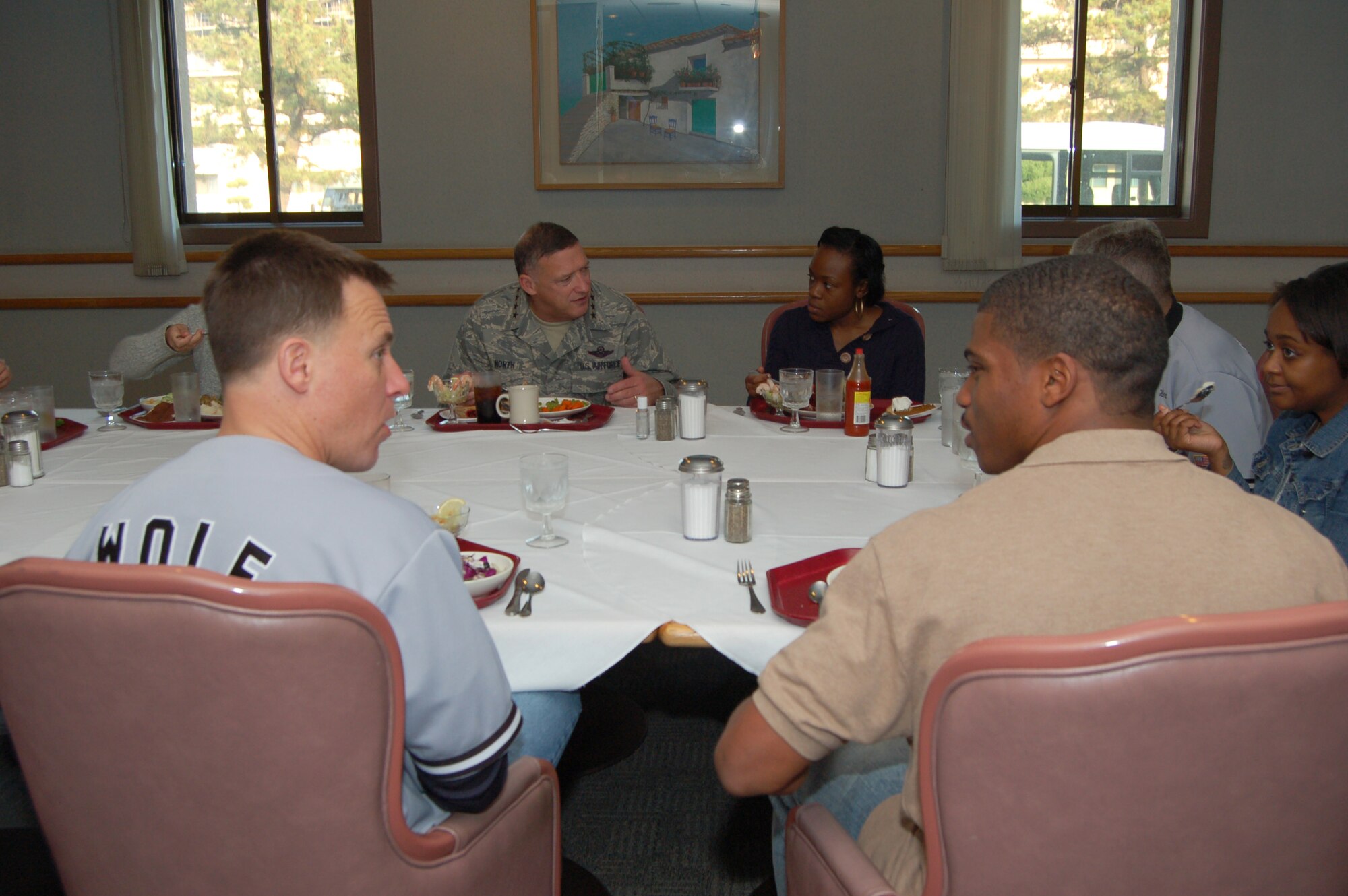 KUNSAN AIR BASE, Republic of Korea--Col. Robert Givens, 8th Fighter Wing commander, and Gen. Gary North, Pacific Air Forces commander, enjoy Thanksgiving dinner with Airmen at the O’Malley Dining Facility 26 November.  Gen. North visited Kunsan with senior leaders from PACAF and the 7th Air Force and members of the PACAF Civilian Advisory Council to help serve the holiday meal and dine with Wolf Pack members. Leaders engaged Airmen in a variety of topics of discussion during this event. (U.S. Air Force photo/Master Sgt. Anna Hayman)