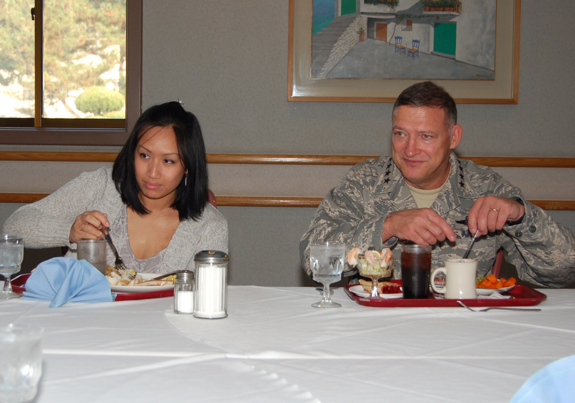 KUNSAN AIR BASE, Republic of Korea—Senior Airman Quyen Luong of the 8th Fighter Wing Chapel enjoys Thanksgiving dinner with Gen. Gary North, Pacific Air Forces commander, the O’Malley Dining Facility here 26 November.  Gen. North visited Kunsan with senior leaders from PACAF and the 7th Air Force and members of the PACAF Civilian Advisory Council to help serve the holiday meal and dine with Wolf Pack members.  Airmen enjoyed dinner and conversation with leaders during this event.  (U.S. Air Force photo/Master Sgt. Anna Hayman)