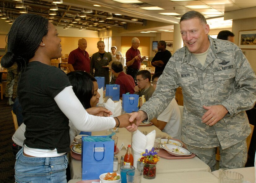 Gen. Gary North, Pacific Air Forces commander, greets Airmen from the 8th Fighter Wing Nov. 26 during Thanksgiving dinner at Osan Air Base, Republic of Korea. General North, Chief Master Sgt. Brooke McLean, PACAF command chief, and four members of the Air Force Civilian Advisory Council toured Osan and Kunsan Air Bases, ROK, to celebrate Thanksgiving with the Airmen serving in the ROK. (U.S. Air Force photo/Tech. Sgt. Jerome Tayborn)