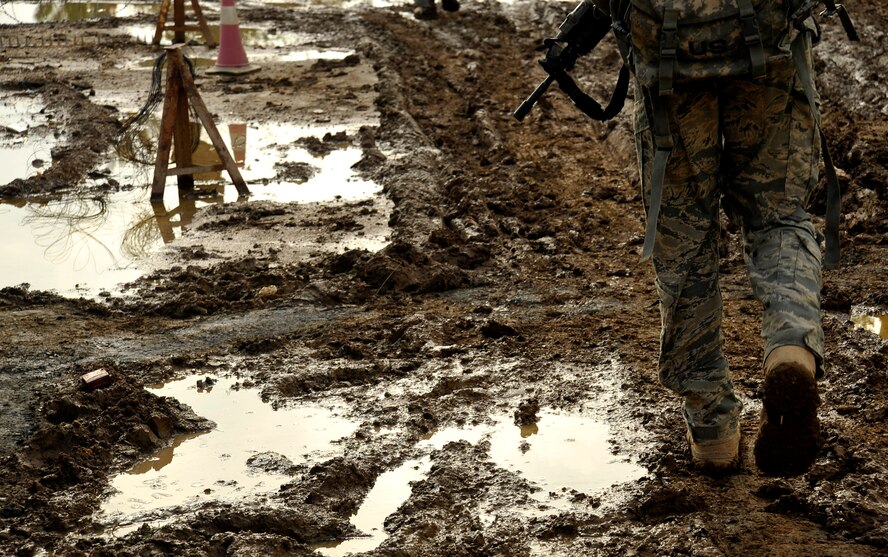 A U.S. Air Force Airman from the 732nd Expeditionary Security Forces Squadron Det 2, deployed to Baghdad, Iraq, walks through the muddy streets of Baghdad while on a foot patrol, Nov. 19, 2009. (U.S. Air Force photo/Staff Sgt. Angelita Lawrence)