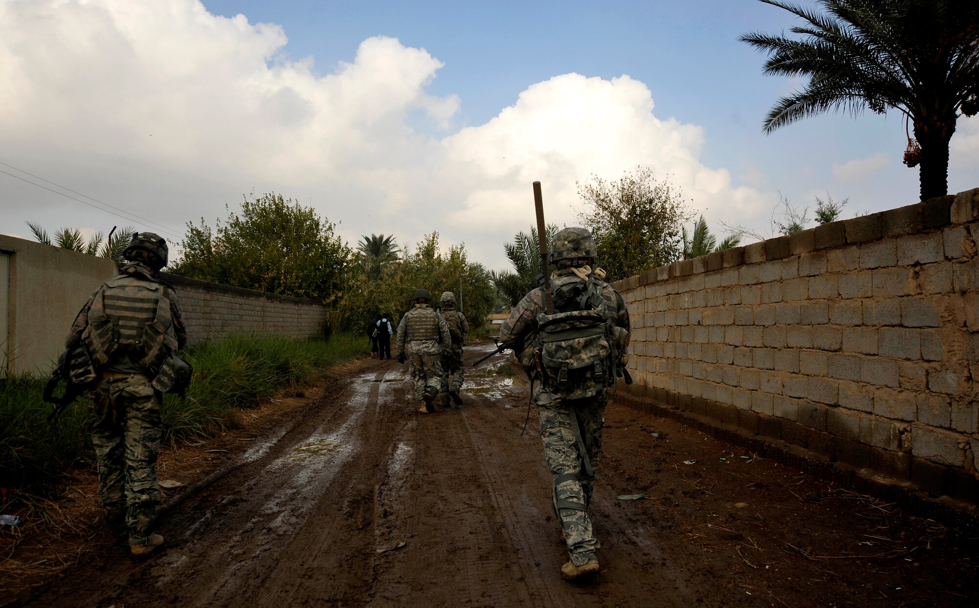 U.S. Air Force Defenders from the 732nd Expeditionary Security Forces Squadron Det. 2, deployed to Baghdad, Iraq, conduct a foot patrol through a Baghdad neighborhood in an effort to assess local checkpoints set up by the Iraqi Police, Nov. 19, 2009. (U.S. Air Force photo/Staff Sgt. Angelita Lawrence)