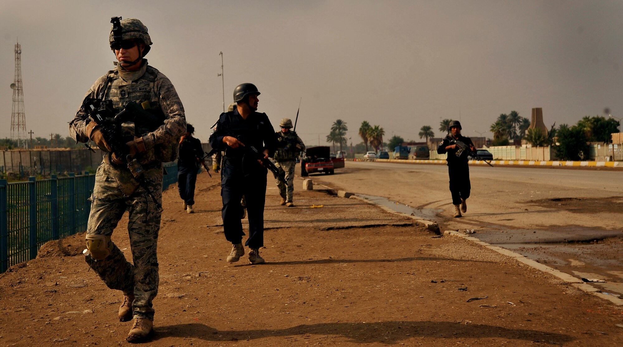 U.S. Air Force Airmen from the 732nd Expeditionary Security Forces Squadron Det. 2, deployed to Baghdad, Iraq, conduct a foot patrol through a Baghdad neighborhood, along with their counterparts from the Iraqi Police, in an effort to assess local checkpoints set up by the Iraqi Police, Nov. 19, 2009. (U.S. Air Force photo/Staff Sgt. Angelita Lawrence)