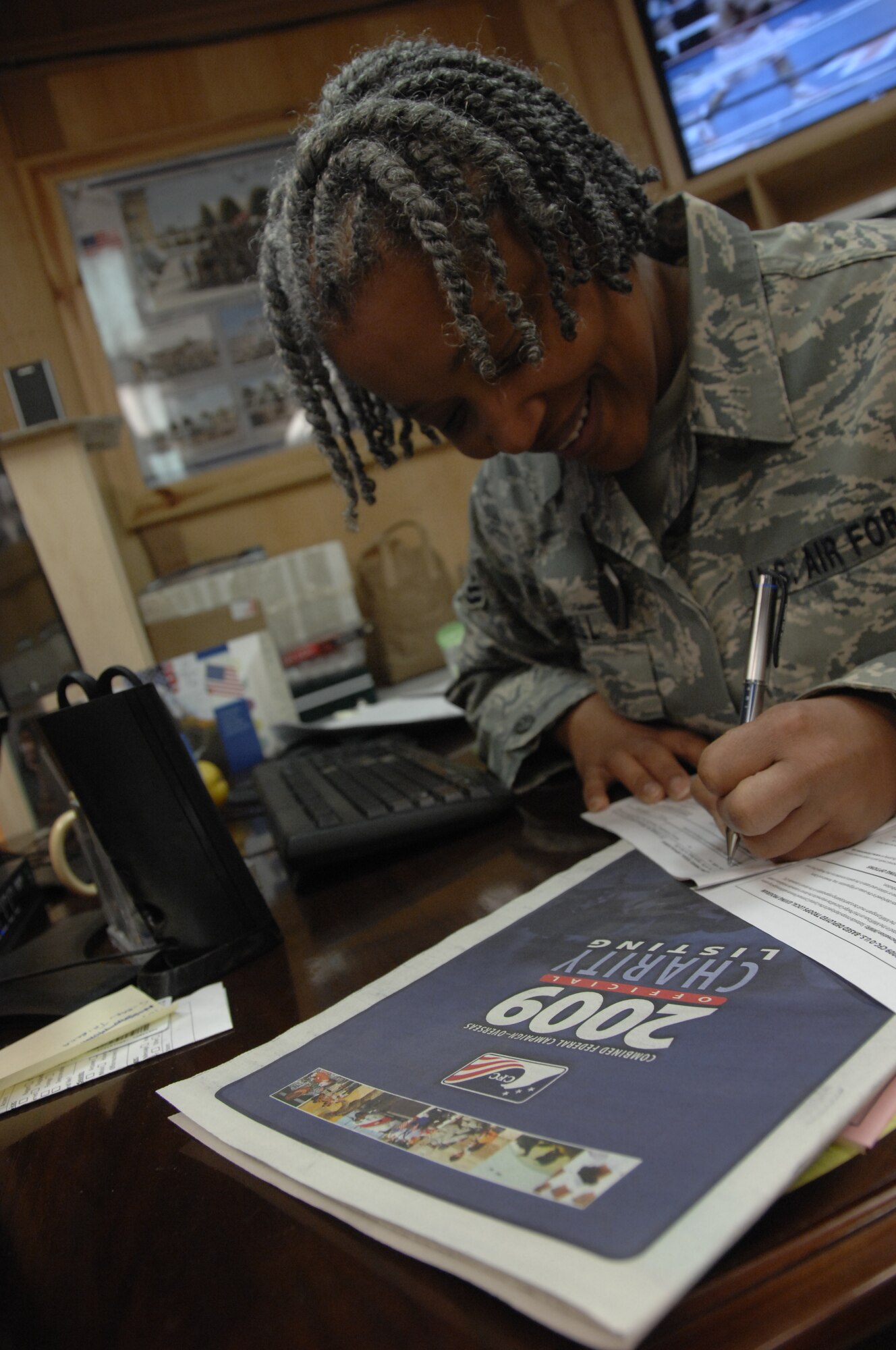 KANDAHAR AIRFIELD, Afghanistan - Tech. Sgt. Pamela Bell fills out a Combined Federal Campaign-Overseas form.  The CFC-O campaign continues until Dec. 4. (U.S. Air Force photo/Senior Airman Timothy Taylor)