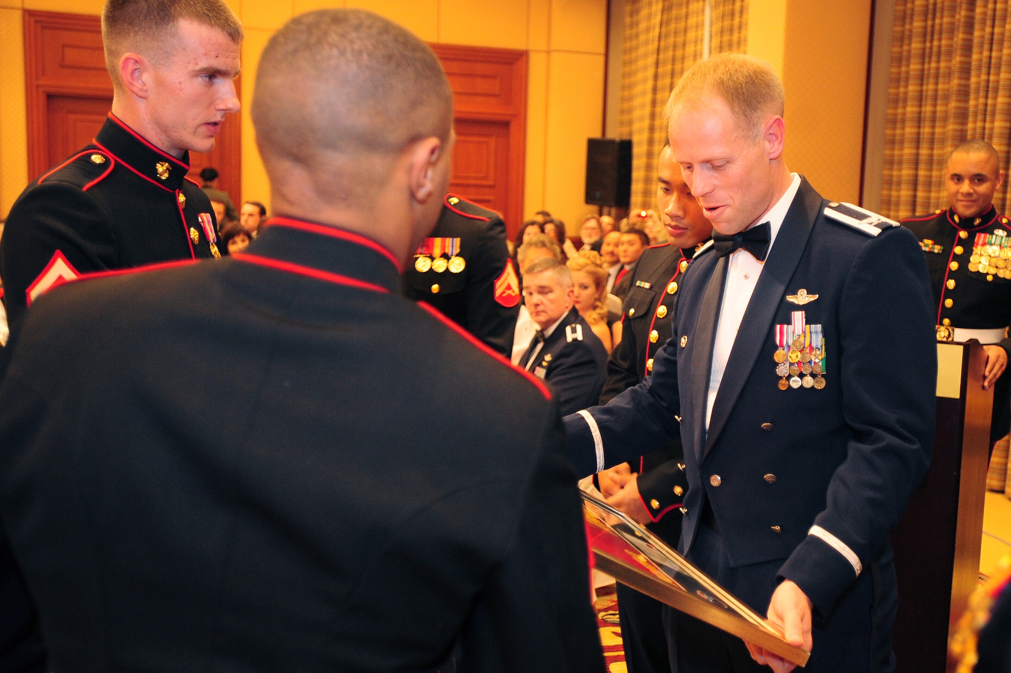 BISHKEK, Kyrgyzstan -- Col. Blaine Holt, 376th Air Expeditionary Wing commander, is presented with a U.S. Embassy (in Kyrgyzstan) Marine Detachment flag at the Marine Corps Ball, Nov. 21, 2009. The U.S. Embassy Marine Detachment celebrated the corps' 234th anniversary with a dinner and ceremony in Bishkek. Colonel Holt was the guest speaker for the event and shared his appreciation of the Marine's service to the U.S. (U.S. Air Force photo/Senior Airman Steele C. G. Britton)