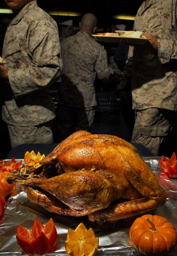 One of 16 whole turkeys lay prepared for Thanksgiving dinner aboard USS Cleveland here Nov. 26. The meal took two days to prepare and fed more than 700 service members. Eighty-nine Navy and Marine cooks, messmen and food-service attendants prepared the fare and a presentation that included baked-bread cornucopias and alligator-shaped loaves.