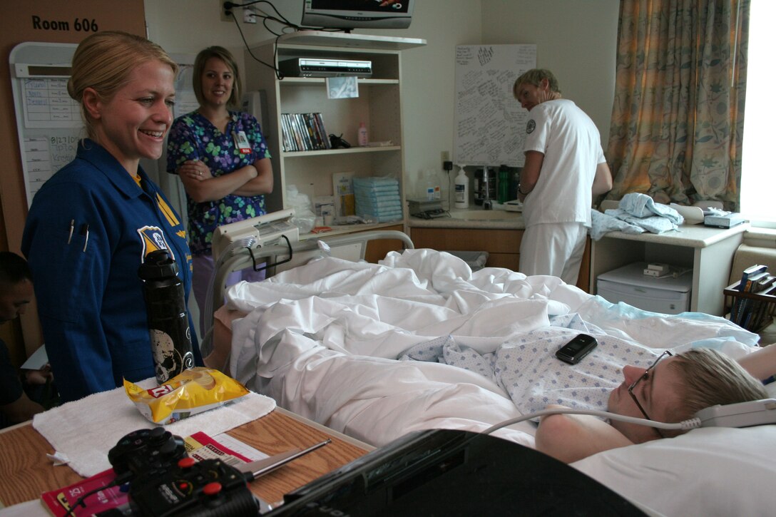 Navy Blue Angel Flight Surgeon Lt. Johannah Valentine visits Aaron Black, 18, at the Children’s Hospital & Medical Center Aug. 28 in Omaha, Neb. The Blue Angels visited the Omaha community with Marine Recruiter Sgt. Karl Krebsbach before they performed at an air show the following weekend.